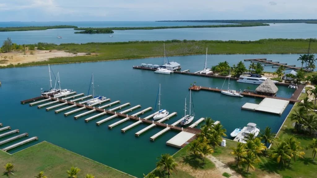Aerial view of Red Rock Marina slips, docks, and thatched-roof waterfront pavilion