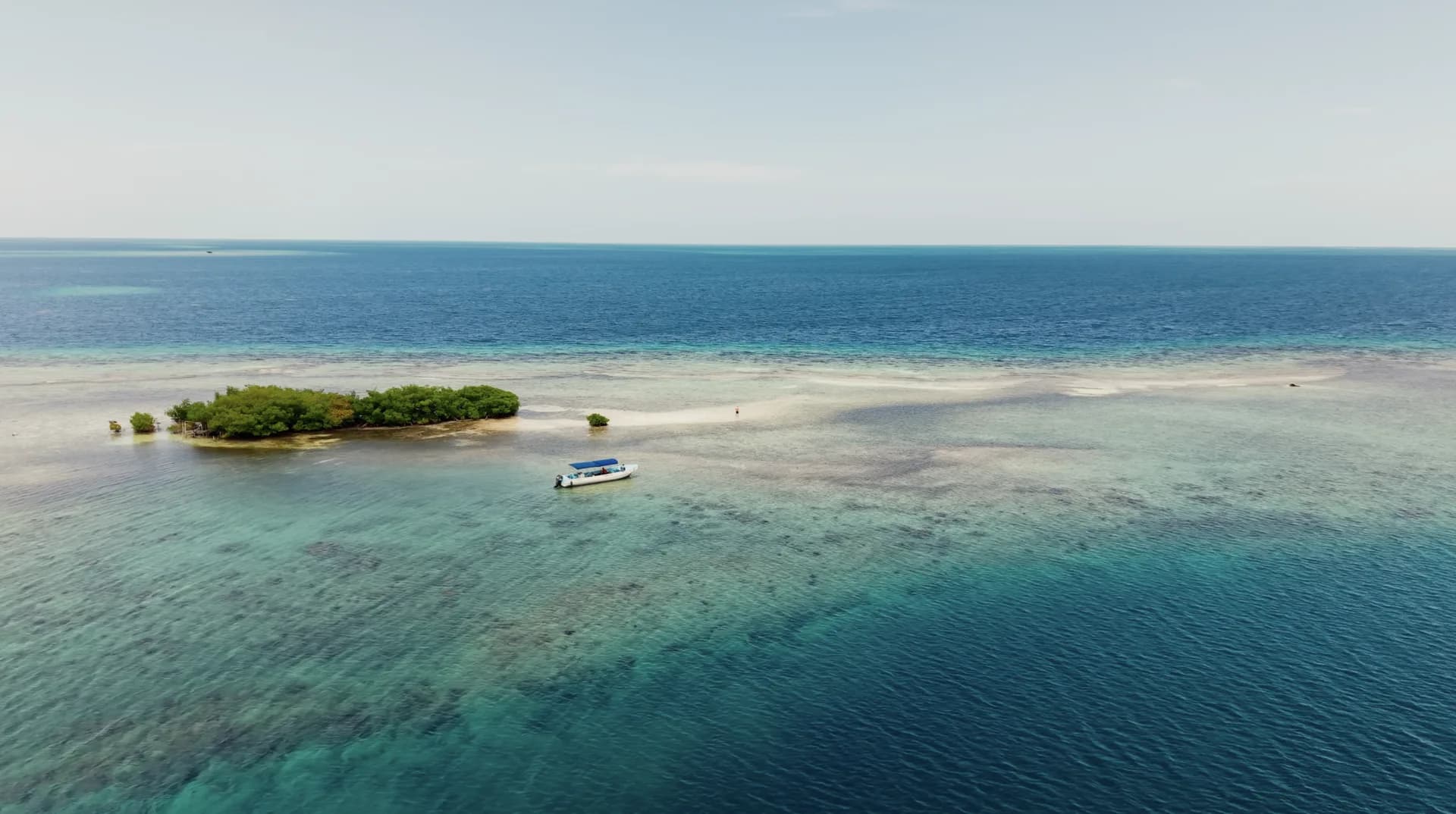 Sandbar caye and reef waters off southern Belize
